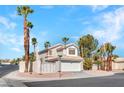 Charming two-story home with a well-maintained yard, gated front area, and a two-car garage at 125 Firecreek Cir, Las Vegas, NV 89107