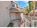Inviting front entry featuring double doors, unique round window, and an attractive tiled porch at 125 Firecreek Cir, Las Vegas, NV 89107