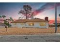 Charming single-story home with a well-maintained exterior, landscaped yard, and desert style landscape at 1400 Cottonwood Pl, Las Vegas, NV 89104