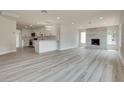 Bright open-concept living room features light wood floors and a modern fireplace with a gray tile surround at 1400 Cottonwood Pl, Las Vegas, NV 89104