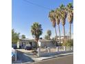 Cozy single-story home with mature trees, a driveway, and white fence at 1804 David Ave, Las Vegas, NV 89101