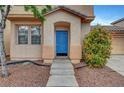 Inviting front entrance with a bright blue door and well-manicured landscaping at 2649 Heathrow St, Las Vegas, NV 89135