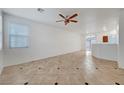 Open living space with stylish tile flooring and ample natural light from the sliding glass doors at 2649 Heathrow St, Las Vegas, NV 89135