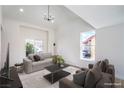 Open-concept living area with contemporary furnishings and vaulted ceiling at 2727 Scotch Heather St, Las Vegas, NV 89142