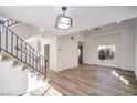 Bright living room with modern staircase and luxury wood flooring at 2727 Scotch Heather St, Las Vegas, NV 89142