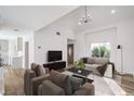 Bright living room with modern furniture, vaulted ceiling and luxury wood flooring at 2727 Scotch Heather St, Las Vegas, NV 89142