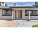 Close-up shot of the front entrance with modern door, decorative pillars and clean landscaping at 2749 Horseshoe Dr, Las Vegas, NV 89120