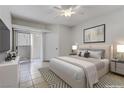Calm main bedroom features neutral decor, tiled floors, ceiling fan, and sliding glass door to patio at 2975 Bluegrass Ln # 811, Henderson, NV 89074