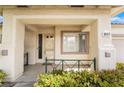 Close-up of a welcoming front porch with decorative railing and manicured bushes at 3057 Sunrise Heights Dr, Henderson, NV 89052