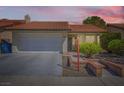 Charming home featuring a tile roof, two-car garage, manicured landscaping, and a brick-lined walkway to the front door at 3314 Astoria Dr, Las Vegas, NV 89121