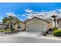 Inviting single-story home boasts desert landscaping, a two-car garage, and a quaint covered entry way, great for curb appeal at 3335 American Mustang Ct, Las Vegas, NV 89122
