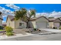Charming single-story home showcasing low-maintenance desert landscaping, a two-car garage, and a neatly paved driveway at 3335 American Mustang Ct, Las Vegas, NV 89122