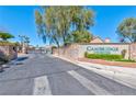 Cambridge Crossing gated community entrance with stone signage and lush landscaping at 3525 Dover Bay St, Las Vegas, NV 89129