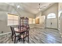 Open dining area with vaulted ceiling, wood floors, chandelier, and natural light at 3525 Dover Bay St, Las Vegas, NV 89129