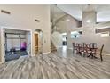 Spacious living room featuring an open layout, staircase, and access to workout area at 3525 Dover Bay St, Las Vegas, NV 89129