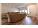 Cozy living room showcasing wood floors, crown molding, and a comfortable, oversized sofa at 363 Terrill Ave, Las Vegas, NV 89183
