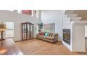 Bright living room featuring light hardwood floors, a charming fireplace, and an abundance of natural light at 3735 Morning Canyon St, Las Vegas, NV 89147