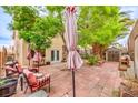 Private patio with shade trees and comfortable seating is perfect for outdoor entertaining and relaxation at 3735 Morning Canyon St, Las Vegas, NV 89147