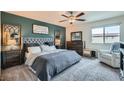 Comfortable main bedroom with a plush upholstered bed, decorative wall art, and a view-enhancing window at 3903 Ramura Ave, North Las Vegas, NV 89084