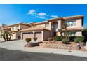 Inviting two-story home featuring a three-car garage, lush landscaping, and a terracotta-tiled roof at 3921 White Castle St, Las Vegas, NV 89129