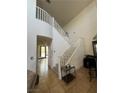 Foyer with high ceilings, staircase, tile floors, and front door at 4017 Radbourne Ave, Las Vegas, NV 89121
