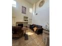 Spacious living room with tall ceilings, tile floors, and a fireplace at 4017 Radbourne Ave, Las Vegas, NV 89121