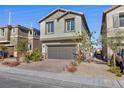Attractive two-story home with a brick driveway, two-car garage, and easily maintained desert landscaping at 4066 Painted Lady Ave, Las Vegas, NV 89141