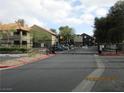 View of the gated entrance to the residential community with well-maintained landscaping at 5038 S Rainbow Blvd # 206, Las Vegas, NV 89118