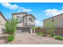 Charming two-story home boasts a well-manicured front yard, a gray two-car garage, and a neutral color scheme at 5846 Bonita Rose St, Las Vegas, NV 89113