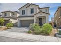 Attractive two-story home with a brick-paved driveway, a two-car garage, and desert landscaping at 6338 Selston Dr, North Las Vegas, NV 89081