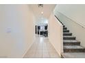 Bright foyer showcasing tile flooring and a staircase leading to the upper level at 6338 Selston Dr, North Las Vegas, NV 89081