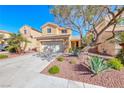Inviting two-story home featuring a well-maintained front yard with desert plants, set against a bright blue sky at 7012 Mercurio Ave, Las Vegas, NV 89131