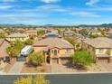 A sprawling community featuring many single Gathering homes nestled against a mountain range backdrop at 7354 Strutting Silver Ct, Las Vegas, NV 89131