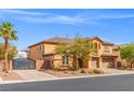 Charming two-story home featuring a three car garage, balcony, and desert landscaping at 7354 Strutting Silver Ct, Las Vegas, NV 89131