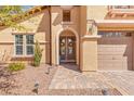 Charming two-story home featuring a large, welcoming front entrance and manicured landscaping at 7354 Strutting Silver Ct, Las Vegas, NV 89131