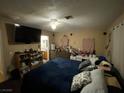 Bedroom featuring carpeted floors, a ceiling fan, a TV, and bright walls at 890 Ripple Way, Las Vegas, NV 89110