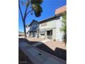 Charming townhome showcasing a well-maintained exterior with a welcoming entrance and landscaped surroundings at 890 Ripple Way, Las Vegas, NV 89110