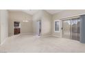 Open-concept living room with a sliding glass door and access to the kitchen at 8904 Marble Dr, Las Vegas, NV 89134