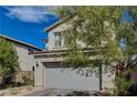 Charming two-story home with a two-car garage and mature tree at 10004 Pasque Flower Ct, Las Vegas, NV 89178