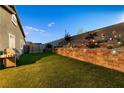 Beautiful backyard with lush landscaping, ambient lighting, and artificial turf for easy maintenance at 10125 Sequoia Falls Pl, Las Vegas, NV 89149