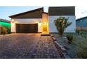 Charming single-Gathering home with brick driveway, garden with stone accents, and welcoming front entrance at 10125 Sequoia Falls Pl, Las Vegas, NV 89149