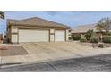 Traditional single-story home with desert landscaping and a three car garage at 1022 Atticus Ave, Henderson, NV 89015
