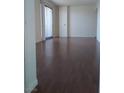 Spacious living room with hardwood floors and sliding glass doors to balcony at 200 W Sahara Ave # 3412, Las Vegas, NV 89102