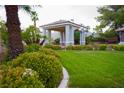 Lush community green with a gazebo, manicured landscaping, and mature palm trees at 2111 Loro Ct, Las Vegas, NV 89117