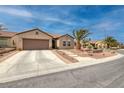 Inviting single-story home featuring a well-maintained lawn, desert landscaping, and a two-car garage at 2217 Merrimack Valley Ave, Henderson, NV 89044