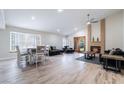 Open-concept living space with hardwood floors, brick fireplace, stylish furnishings, and ample natural light at 289 Garwood Ct, Henderson, NV 89074