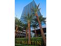 Exterior of The Martin building and sign with palm trees and lush landscaping at 4471 Dean Martin Dr # 1707, Las Vegas, NV 89103