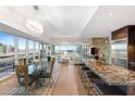 Open-concept living area with modern furnishings, sleek kitchen, and floor-to-ceiling windows with city views at 4471 Dean Martin Dr # 1707, Las Vegas, NV 89103