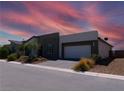 Single-story home with a modern two-tone exterior and a two-car garage at 4557 E Cactus Canyon Dr, Pahrump, NV 89061