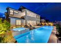 Inviting backyard featuring a sparkling pool, hot tub, and lounge chairs, perfect for outdoor relaxation at 472 Windstone Crest Ave, Las Vegas, NV 89138